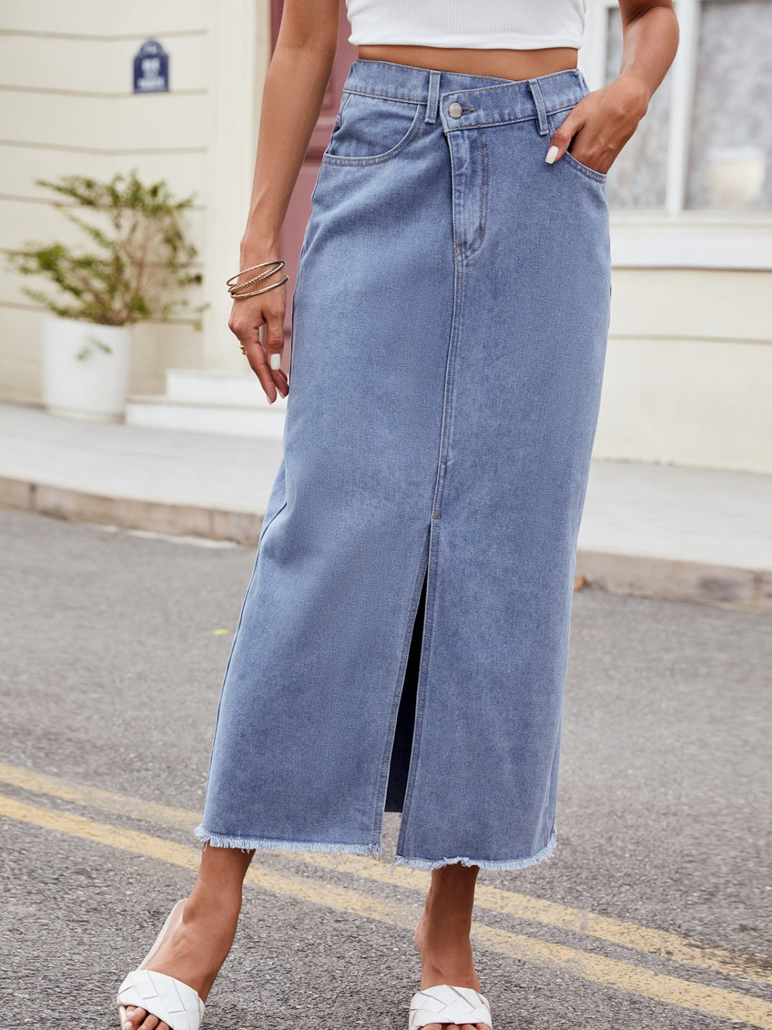 BELLA Trendsi asymmetrical waist denim skirt with a slit, showcasing its stylish design and trendy fit in a casual setting.