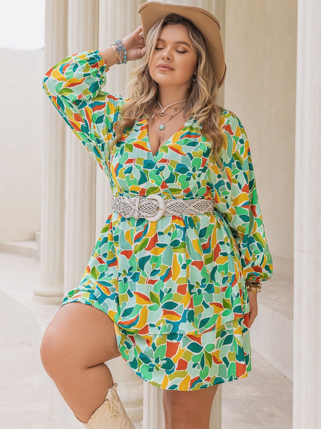 Plus size printed surplice long sleeve mini dress by BELLA featuring a stylish pattern and a flattering silhouette.