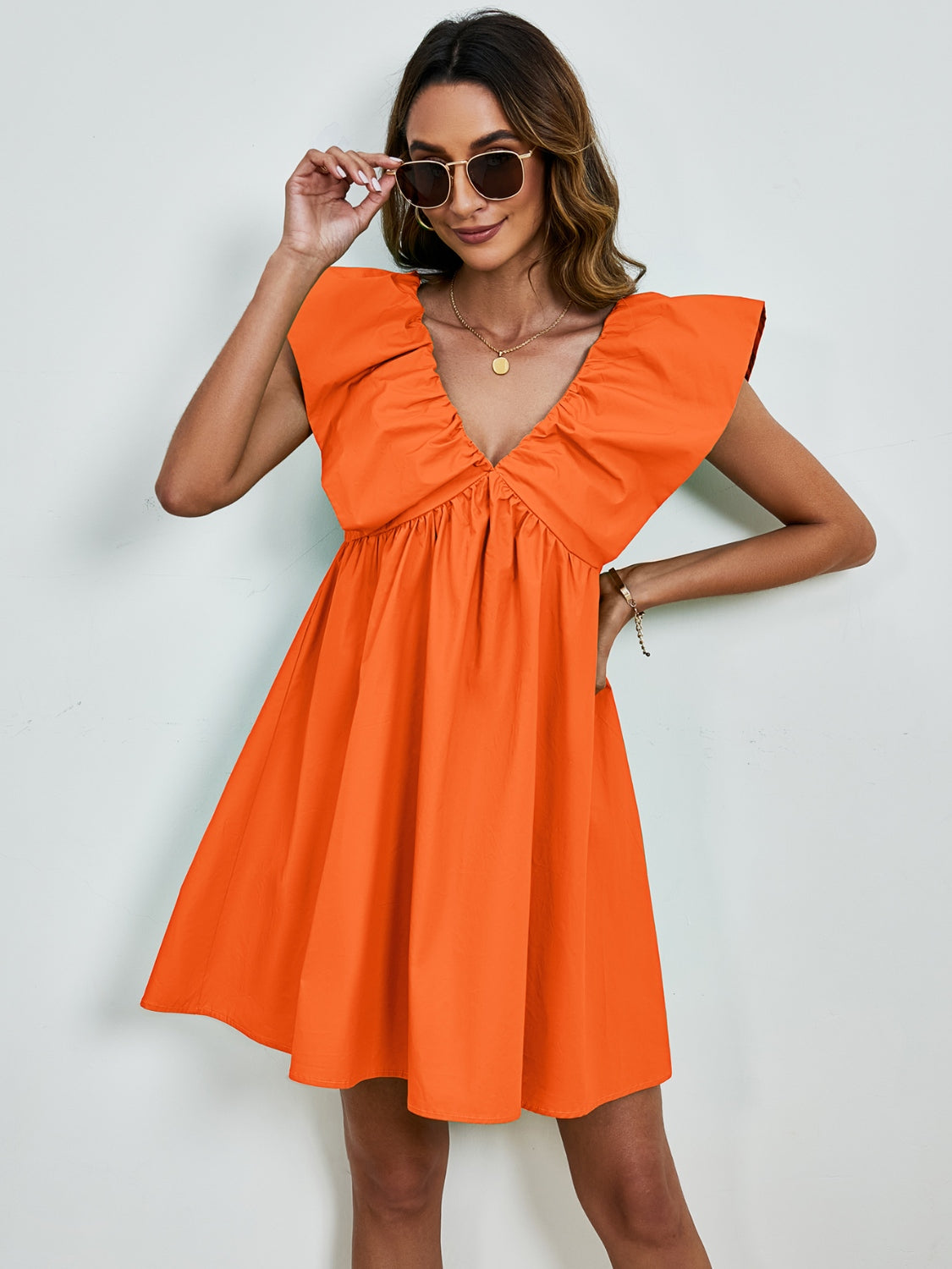 BELLA V-neck cap sleeve mini dress featuring a fitted silhouette and stylish design, perfect for casual or semi-formal occasions.