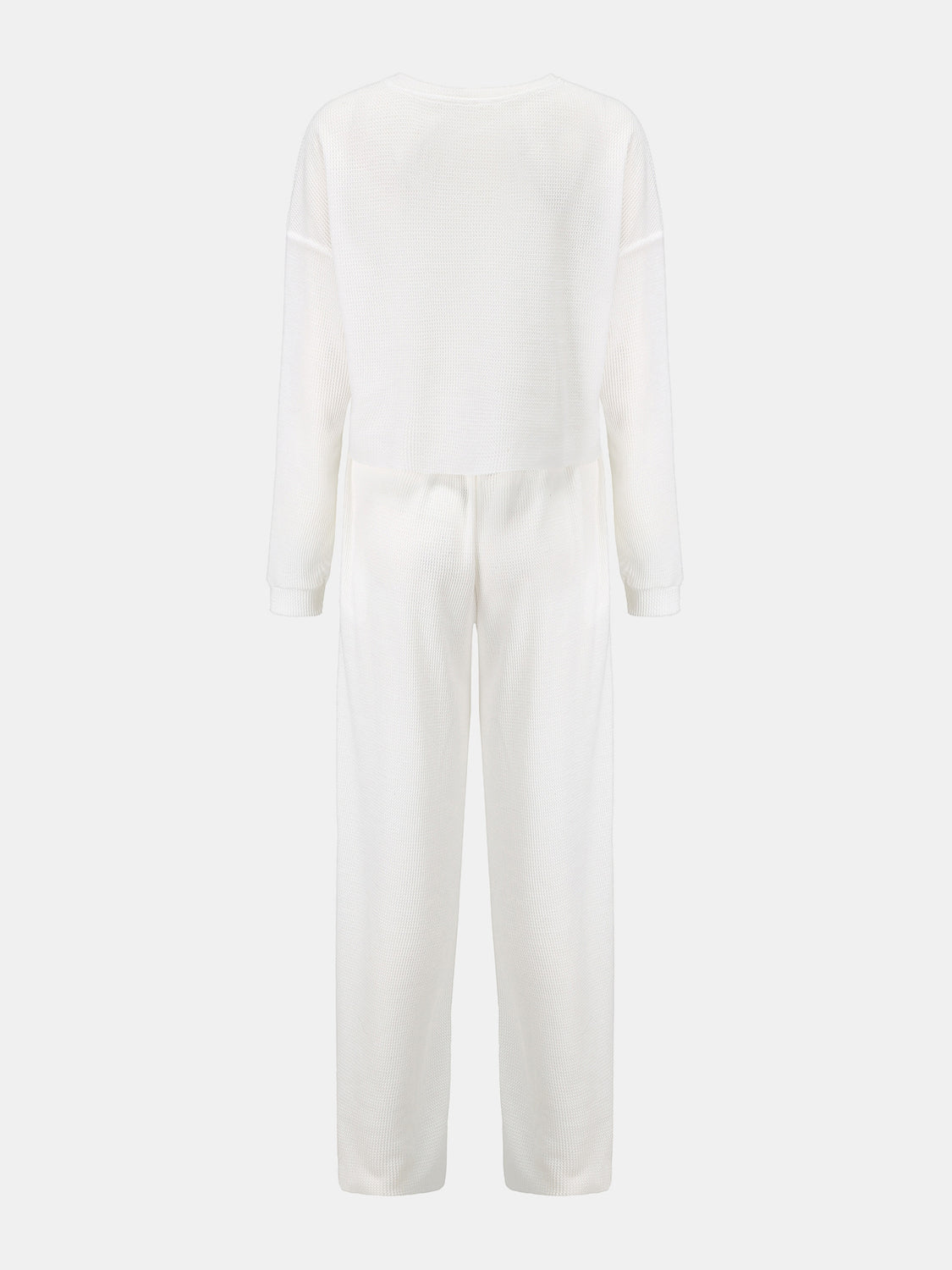 BELLA waffle-knit round neck top and pants set in a cozy, textured fabric, featuring a relaxed fit and casual style.