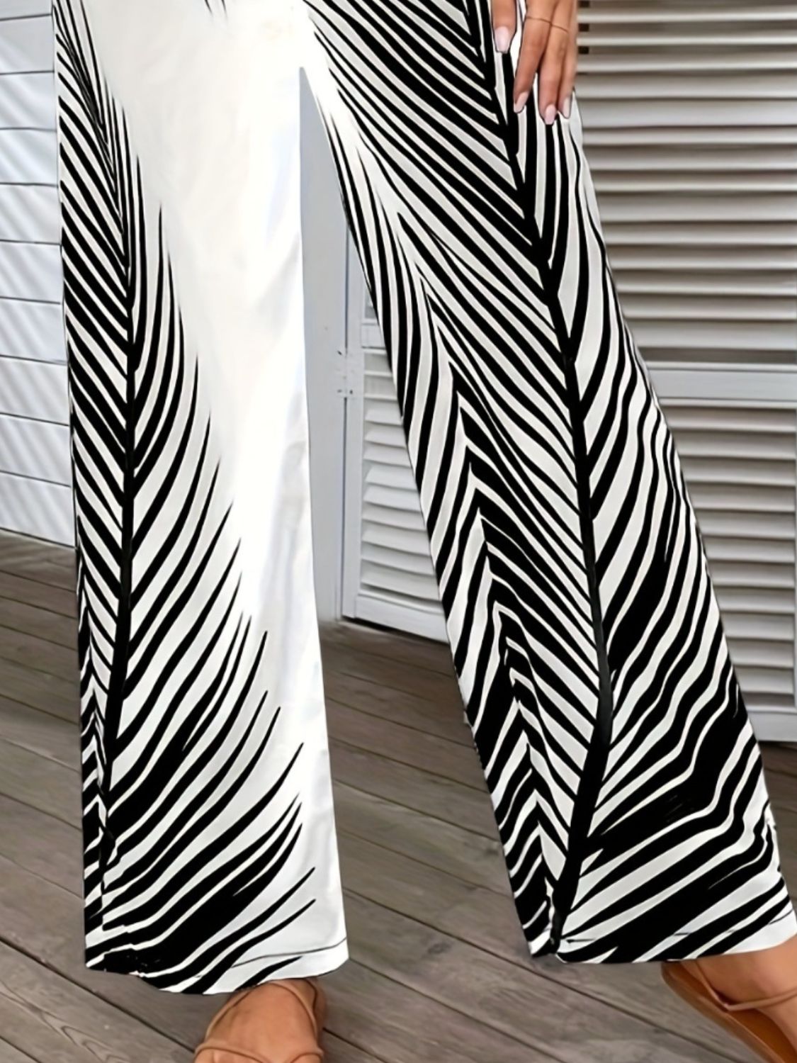 Printed wide-leg pants by BELLA from Trendsi, featuring a flowy fabric and bold pattern, shown on a model.