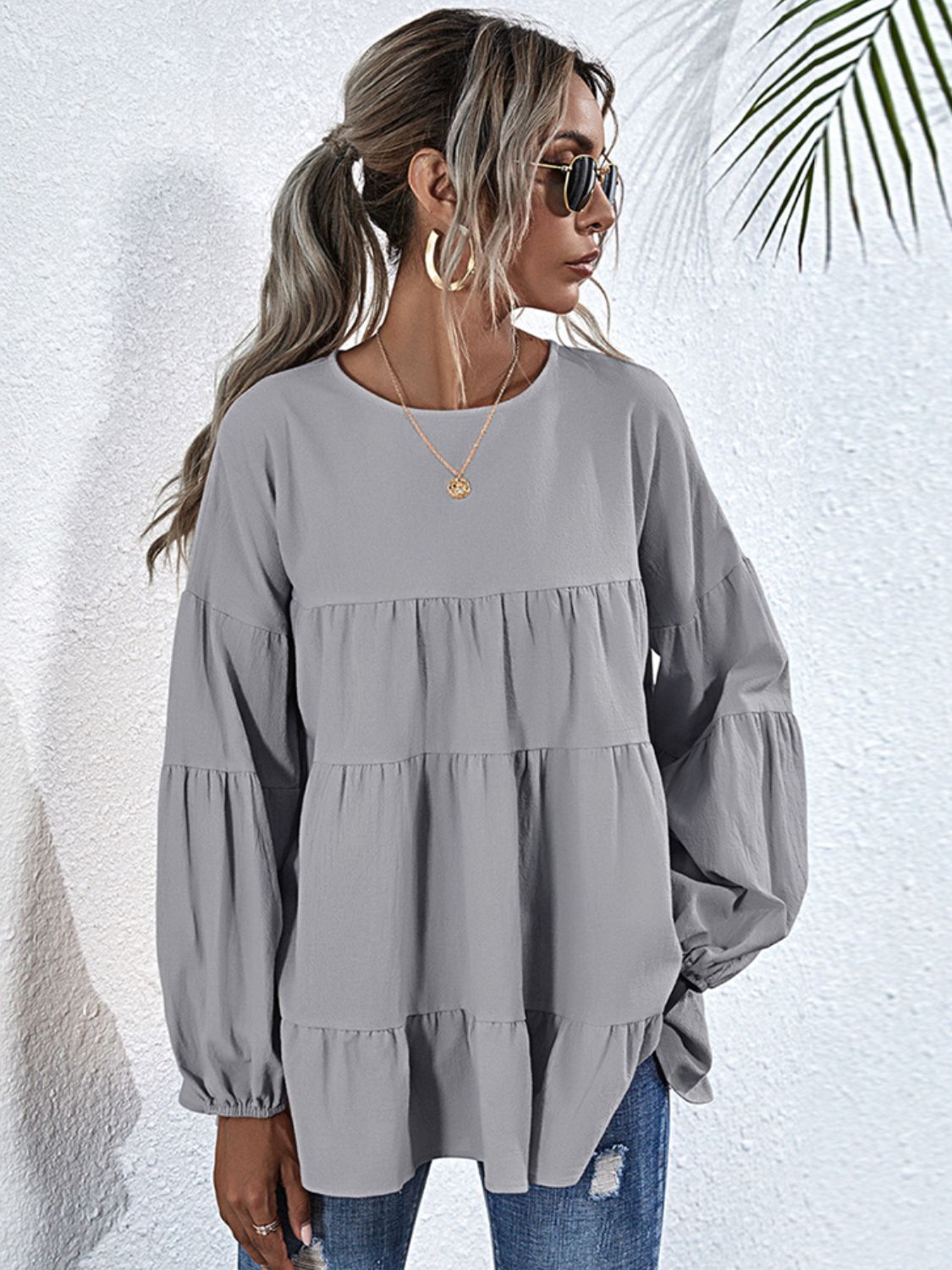 Shiny round neck dropped shoulder tiered blouse by BELLA featuring a stylish, shiny fabric and layered design.