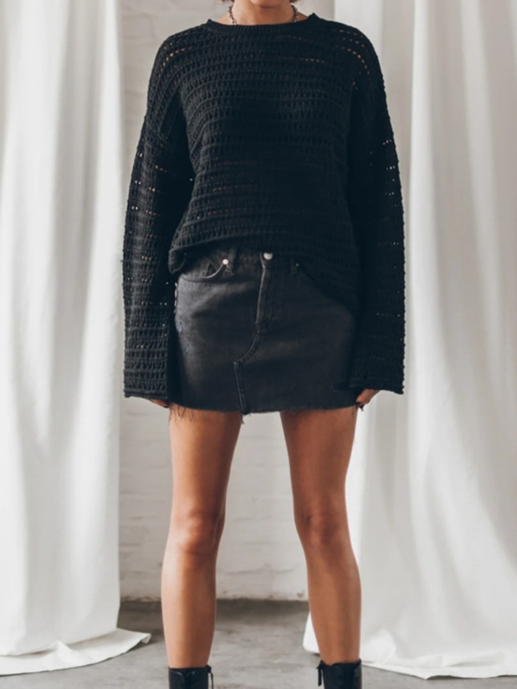 BELLA openwork round neck dropped shoulder knit top featuring a stylish and breathable design with intricate knit pattern.