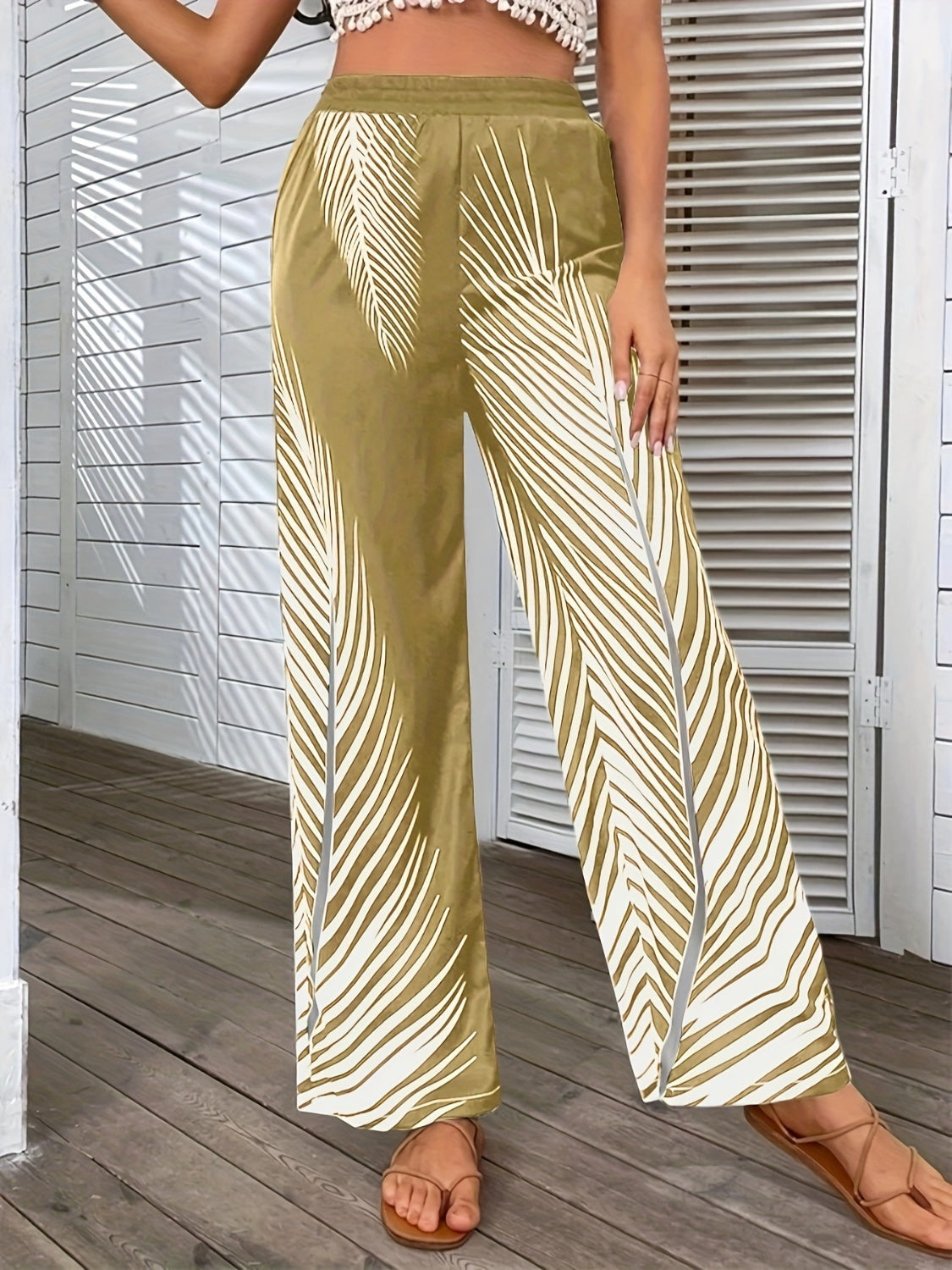 Printed wide-leg pants by BELLA from Trendsi, featuring a flowy fit and bold pattern, shown on a model.
