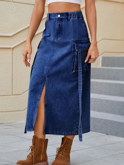 BELLA slit pocketed high waist denim skirt shown on a model, featuring a classic blue wash and stylish front slit detail.
