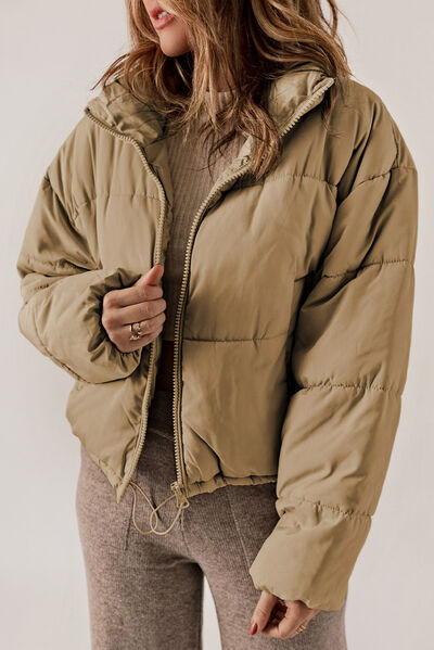 BELLA trendy puff jacket, stylish and warm, featuring a padded design with a high collar and zip closure for a fashionable look.