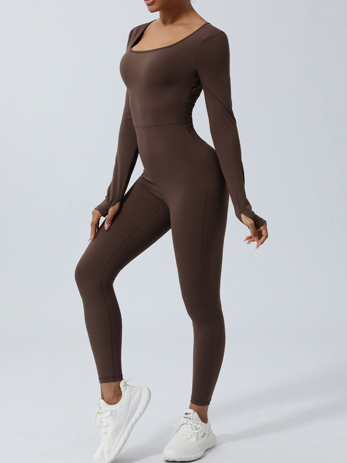 Backless long sleeve jumpsuit by BELLA, featuring twisted design and fitted silhouette, styled for a trendy look.