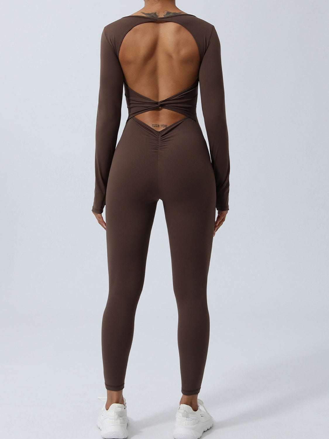 BELLA twisted backless long sleeve jumpsuit featuring a fitted silhouette and stylish design, shown on a model.