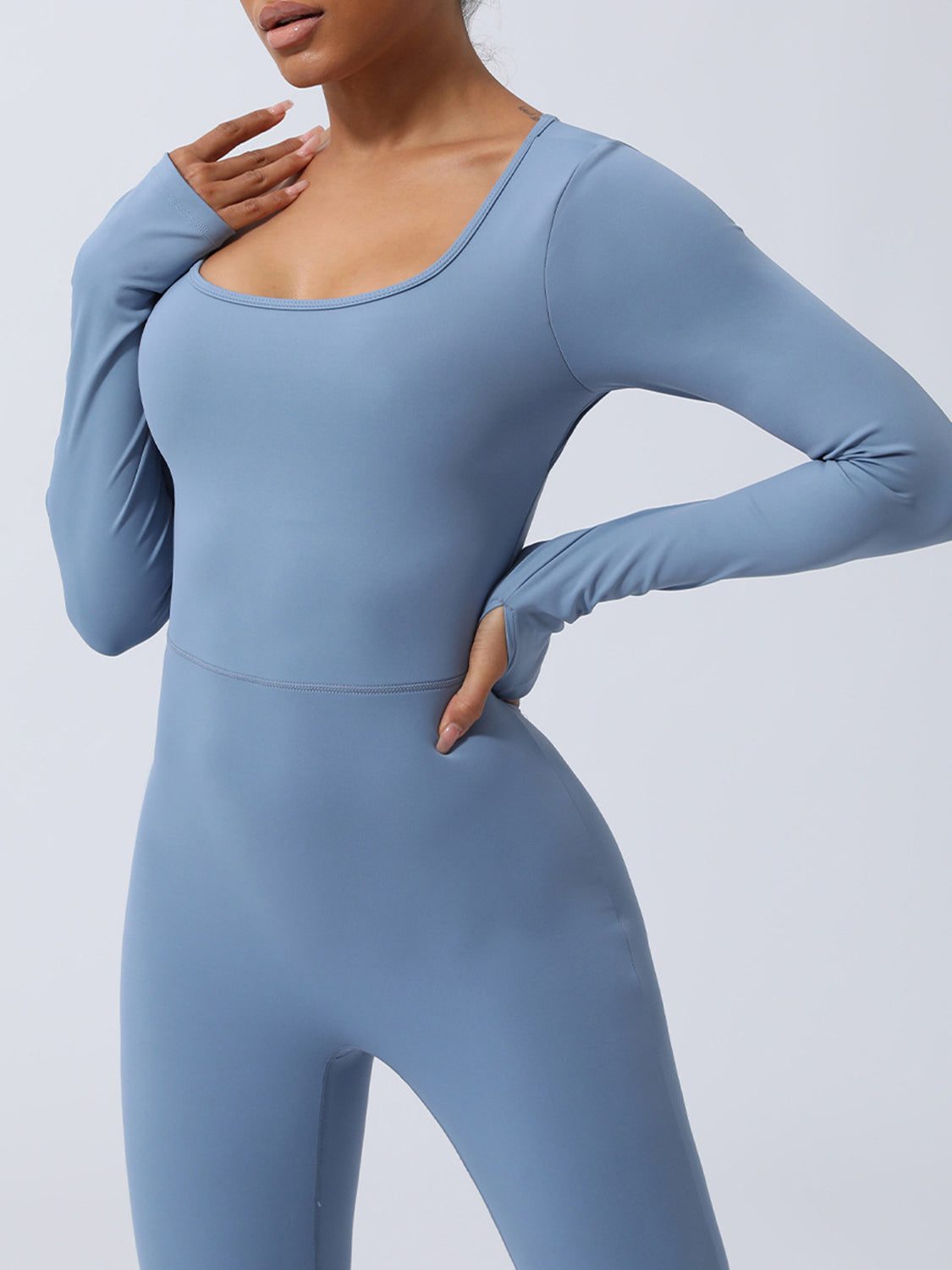 BELLA trendsi twisted backless long sleeve jumpsuit featuring a sleek design and fitted silhouette on a model.