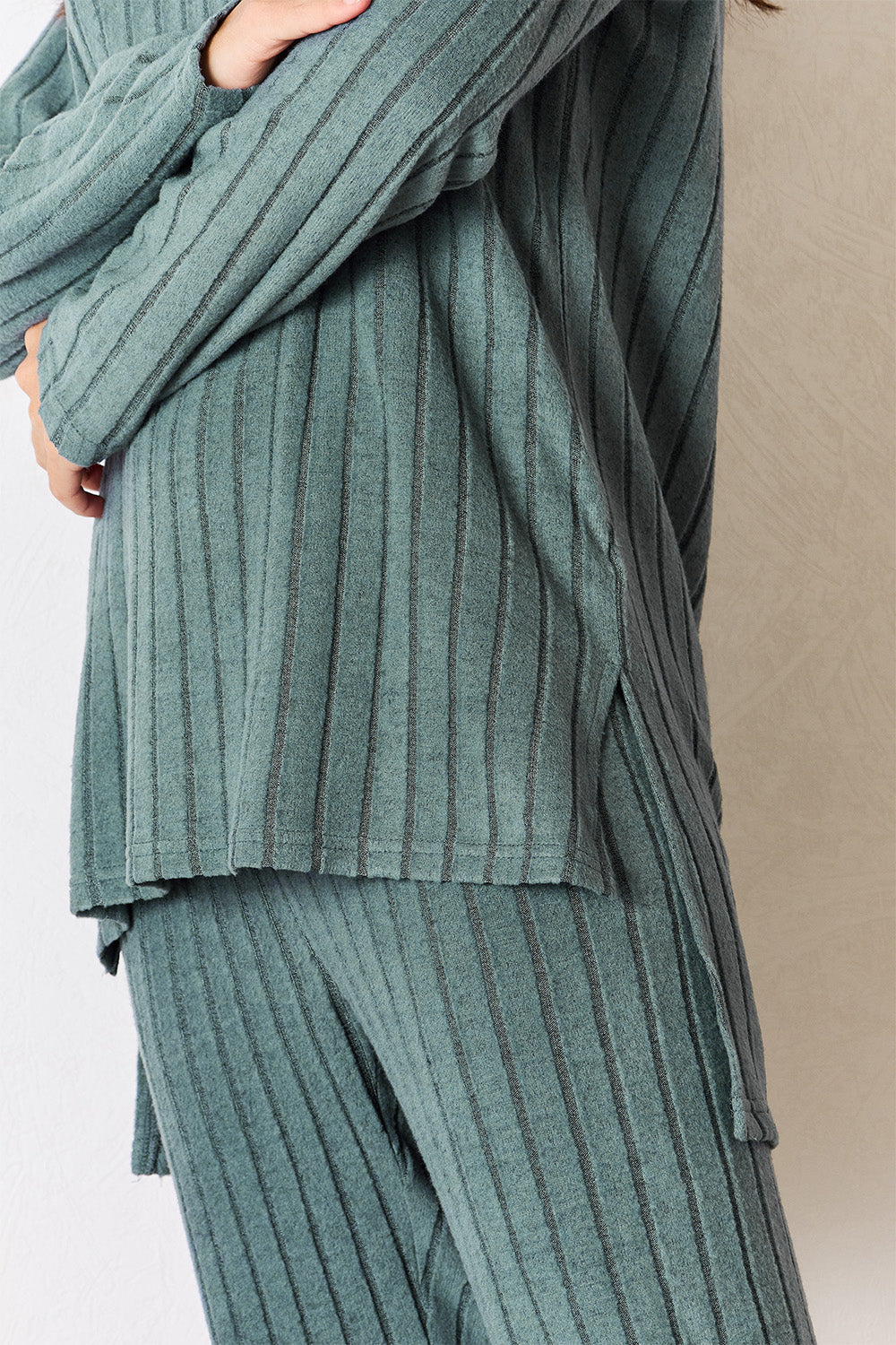 BELLA BLA High-Low Slit Top and Pants Set from Trendsi, featuring a stylish high-low hem top with matching pants in a fashionable design.